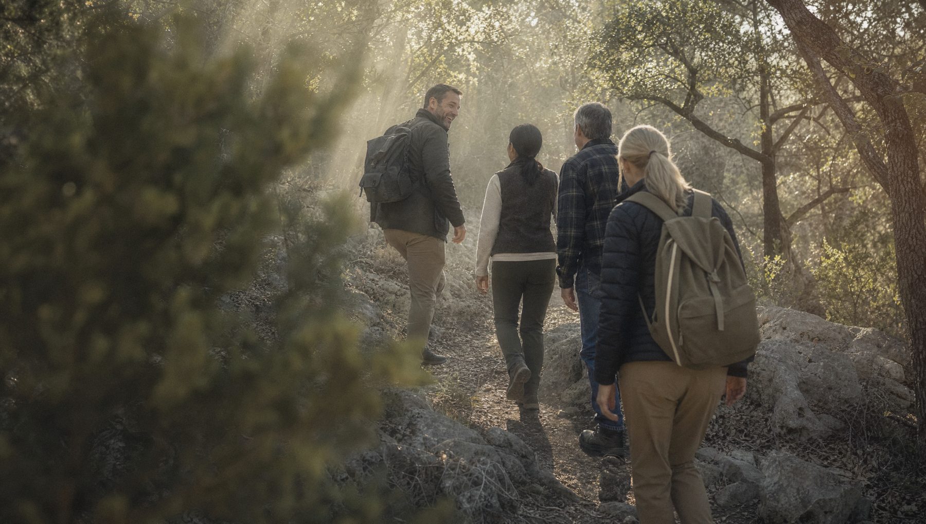 Members hiking a wooded trail